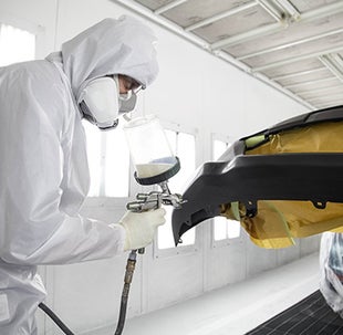Collision Center Technician Painting a Vehicle | Bennett Toyota in Allentown PA