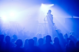 Signer in silhouette in front of a big crowd