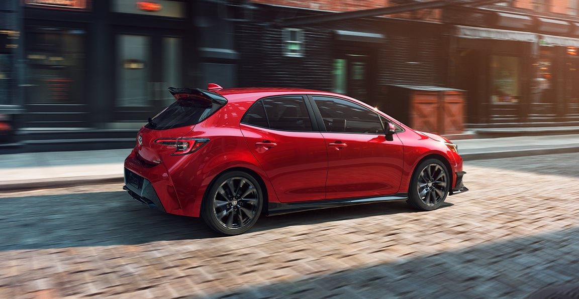 Bennett Toyota of Allentown is a Car Dealership near Coopersburg, PA | 2021 Toyota Corolla Hatchback driving on brick road