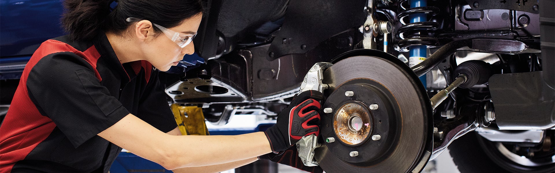 Bennett Toyota of Allentown is a Car Dealership near Reading, PA | Toyota mechanic fixing brakes on a Tacoma