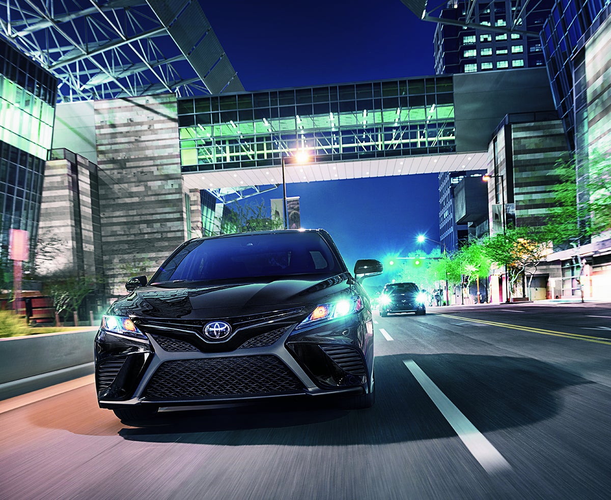 Bennett Toyota of Allentown is a Car Dealership near Fullerton PA | 2020 Toyota Camry driving through city at night