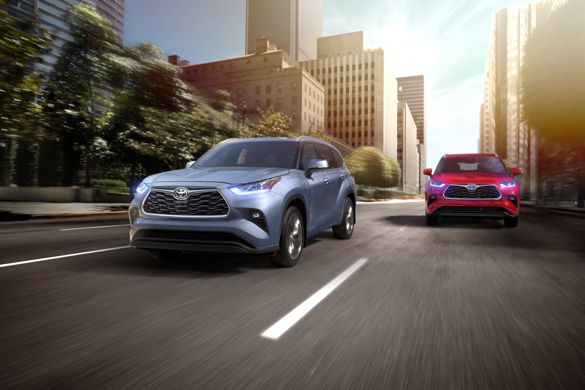 Compare the 2021 Toyota Highlander vs. the 2021 Honda Pilot at Bennett Toyota | Two 2021 Toyota Highlanders driving beside each other