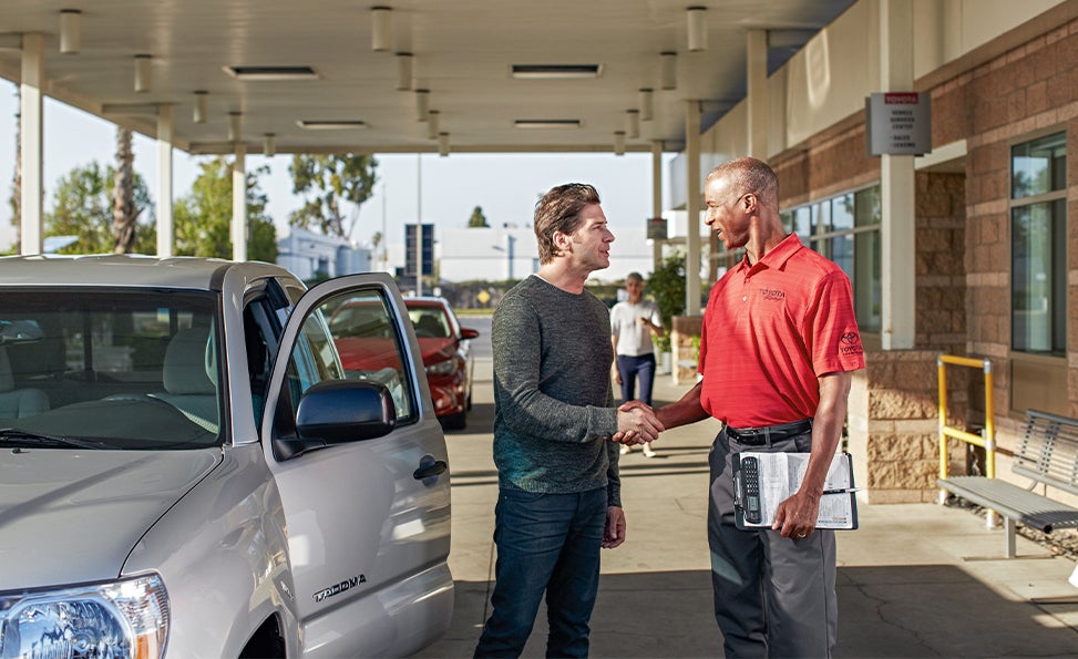 Bennett Toyota of Allentown is a Car Dealership near Center Valley PA | Toyota Service Advisor shaking hands with customer