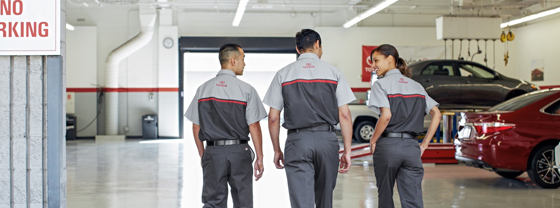 Difference between synthetic oil & conventional oil at Bennett Toyota | Toyota service technicians walking into the shop