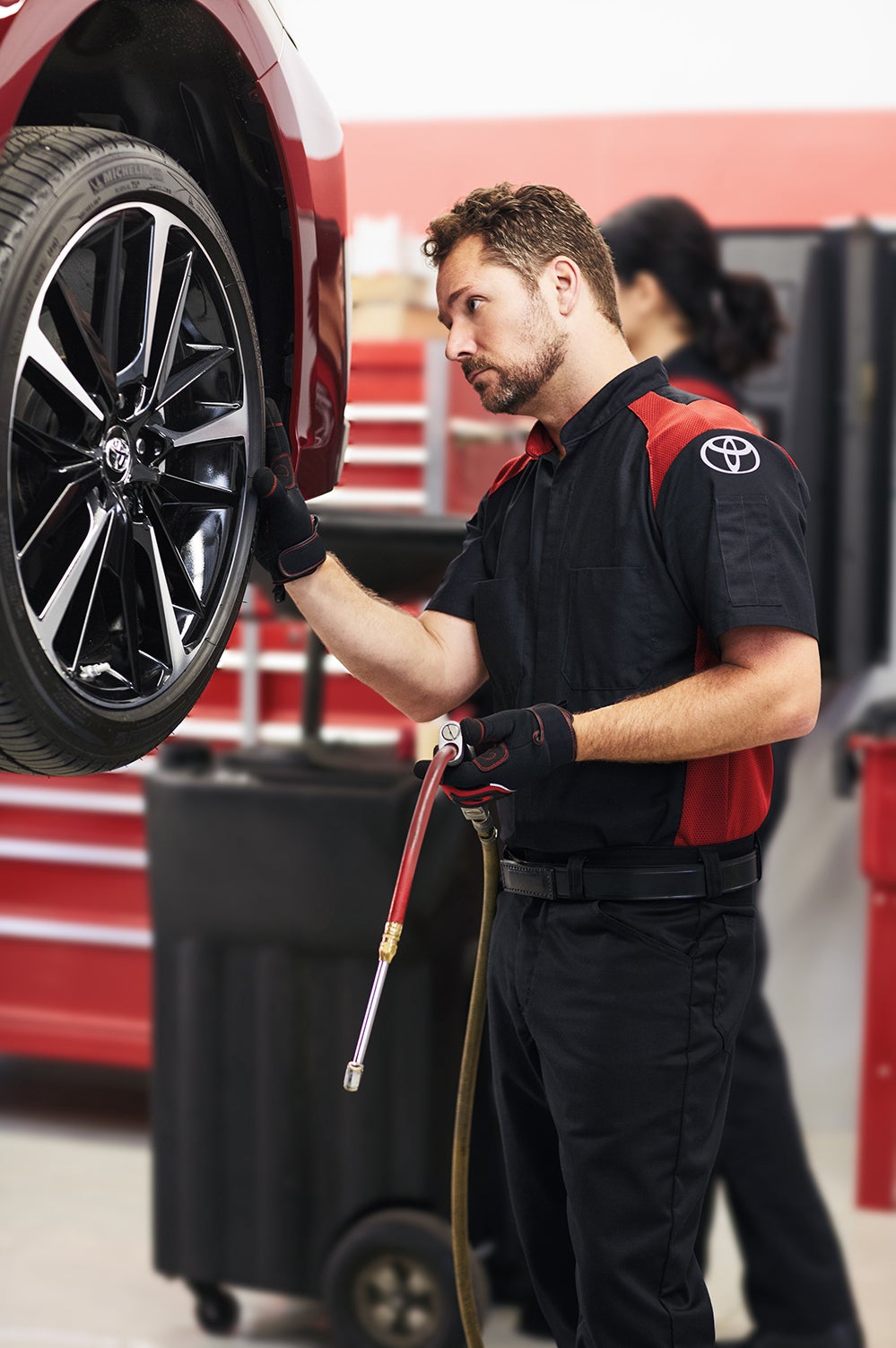 Bennett Toyota of Allentown is a Car Dealership near Fogelsville, PA | Toyota mechanic checking tires on a Toyota vehicle