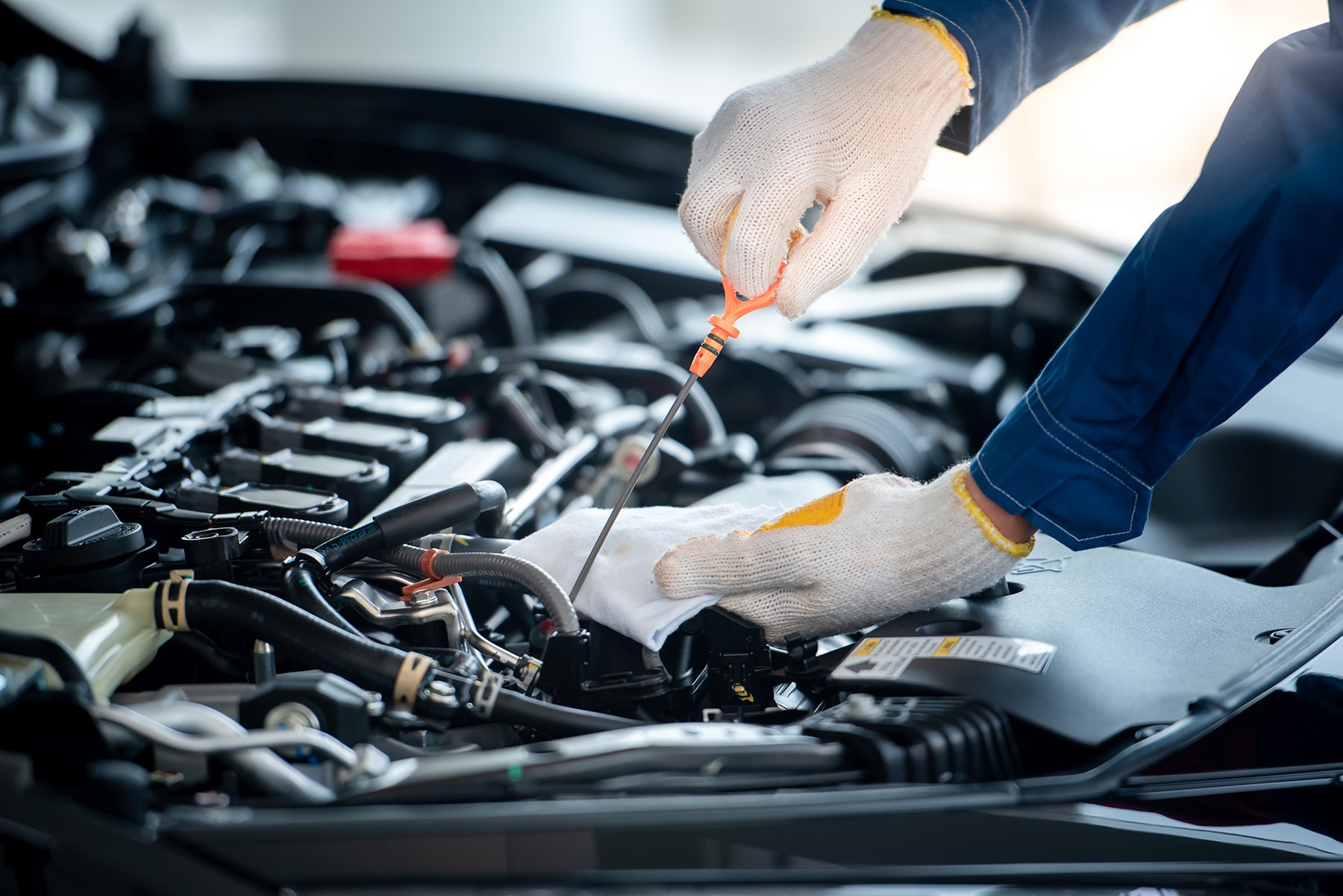 Difference between synthetic oil & conventional oil at Bennett Toyota | Toyota Mechanic checking oil