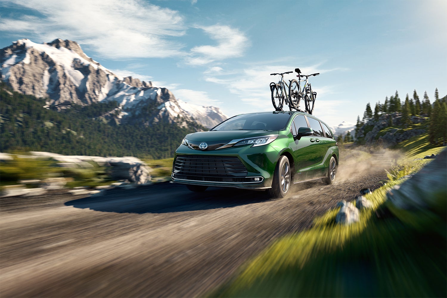 Toyota Hybrid for Everyone at Bennett Toyota | 2022 Toyota Sienna Hybrid driving off road with a bike on top