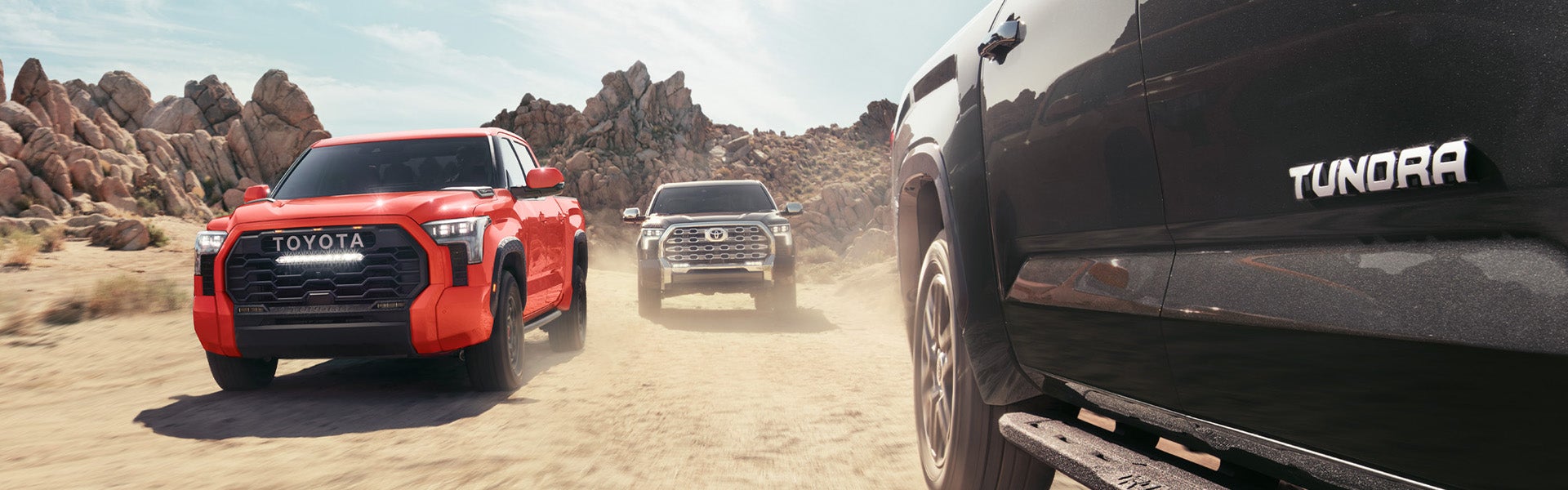 The All-New 2022 Toyota Tundra at Bennett Toyota in Allentown | Three 2022 Toyota Tundra Vehicles Driving Next to Each Other Through Desert