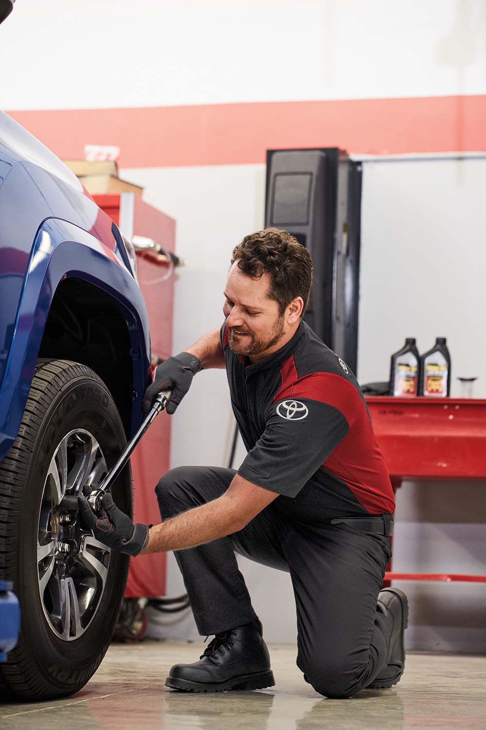 Winter Tires vs. All Season Tires at Bennett Toyota in Allentown, PA | Toyota service technician replacing tires on a Toyota Tacoma