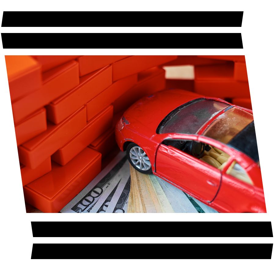 Defining GAP Insurance at Bennett Toyota in Allentown, PA | A Photo of a Toy Car Crashing into a Lego Brick Wall While Sitting on Several Hundred Dollar Bills